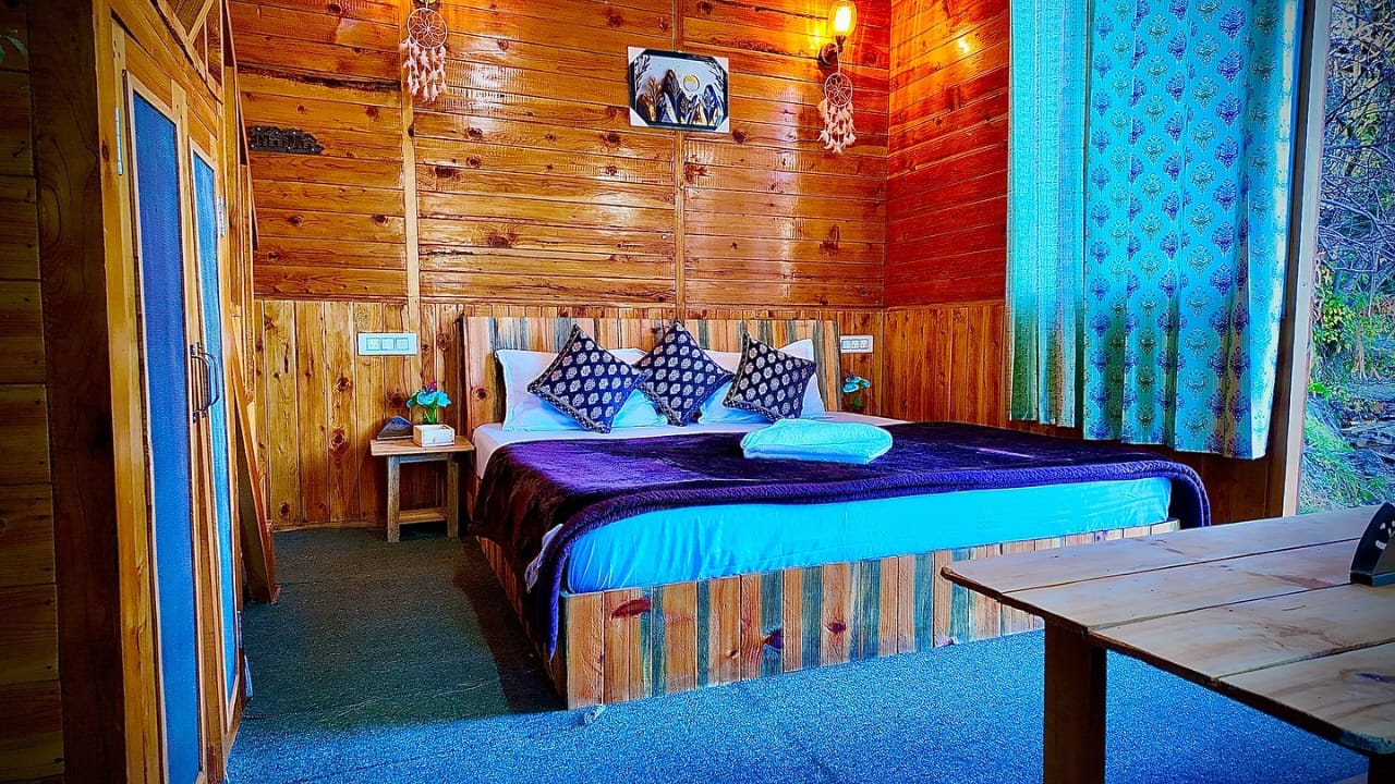 Wood-lined bedroom at Woodland Treehouse Jibhi