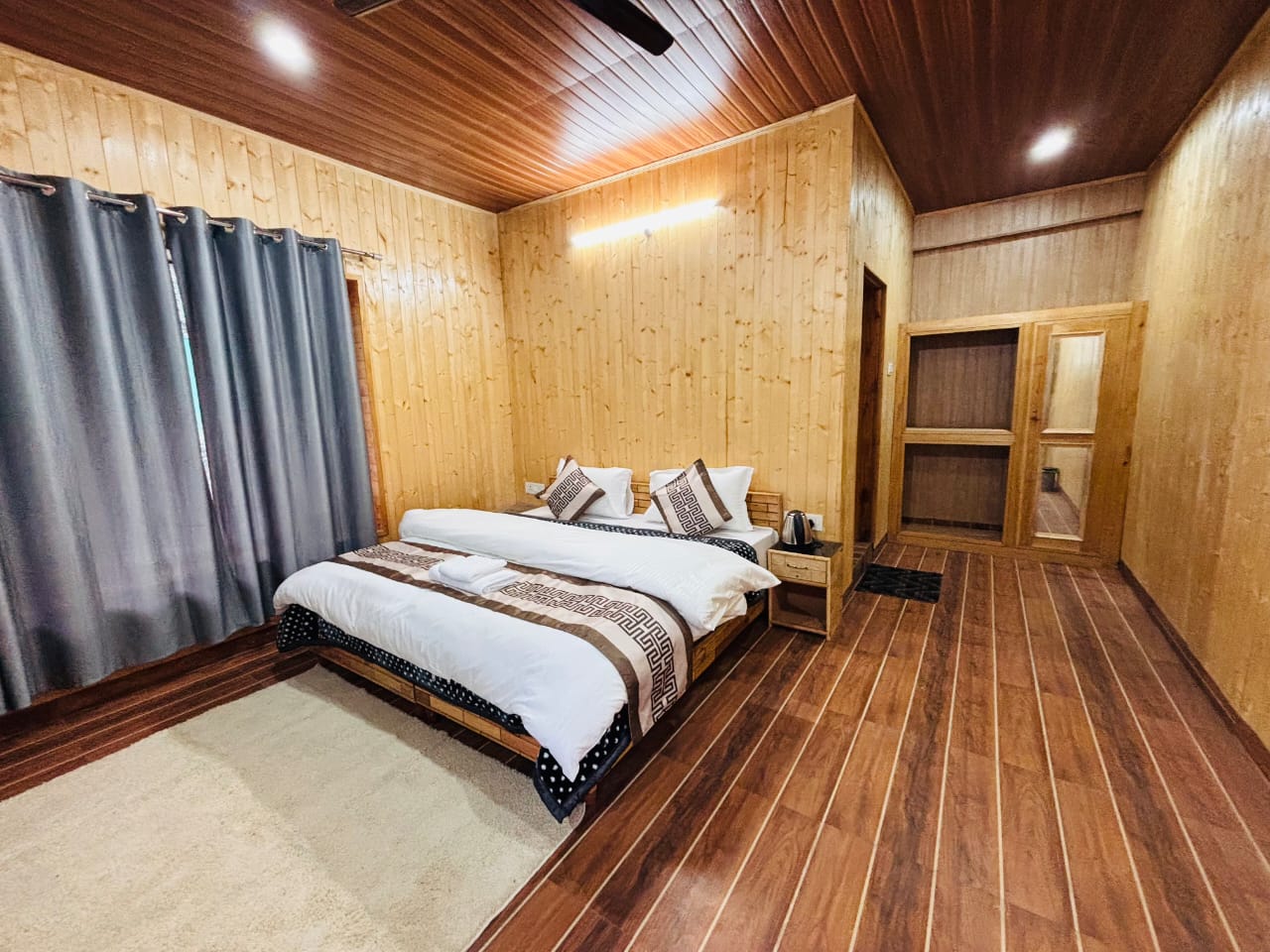 Wood-panelled bedroom at Villa Stone Riverside Homestay