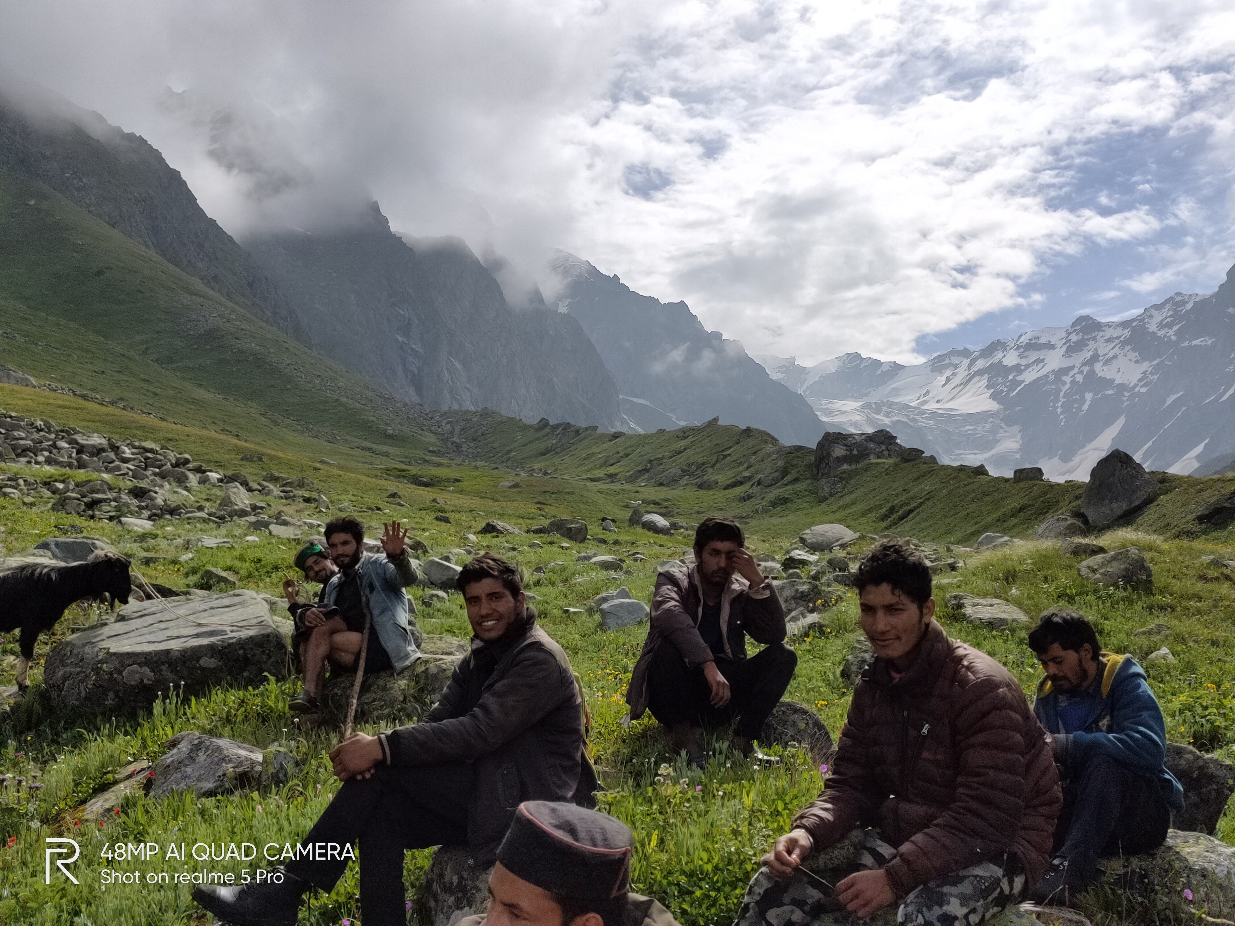 Small group walking together across an alpine valley