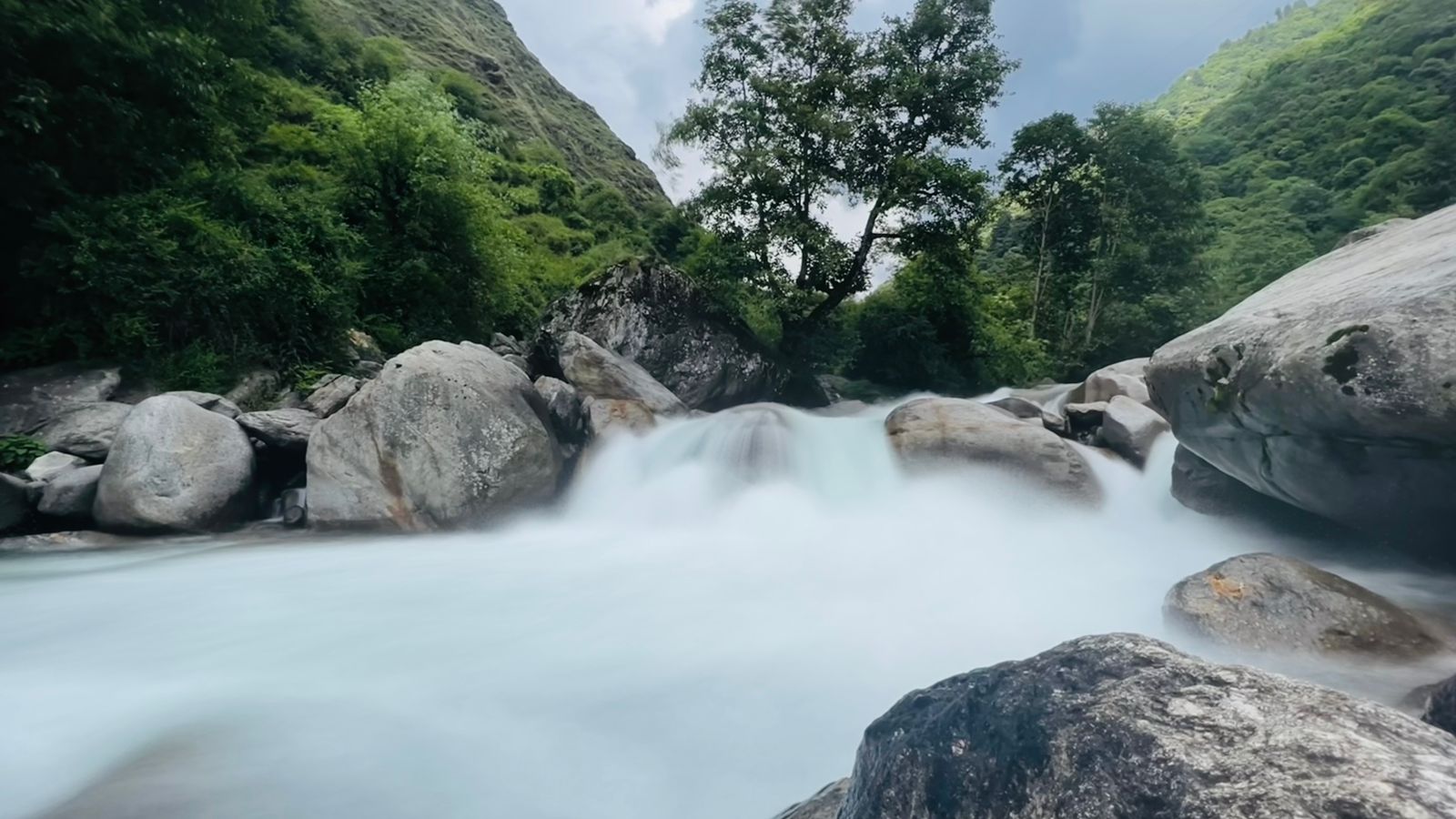 Mountain river flowing around large boulders