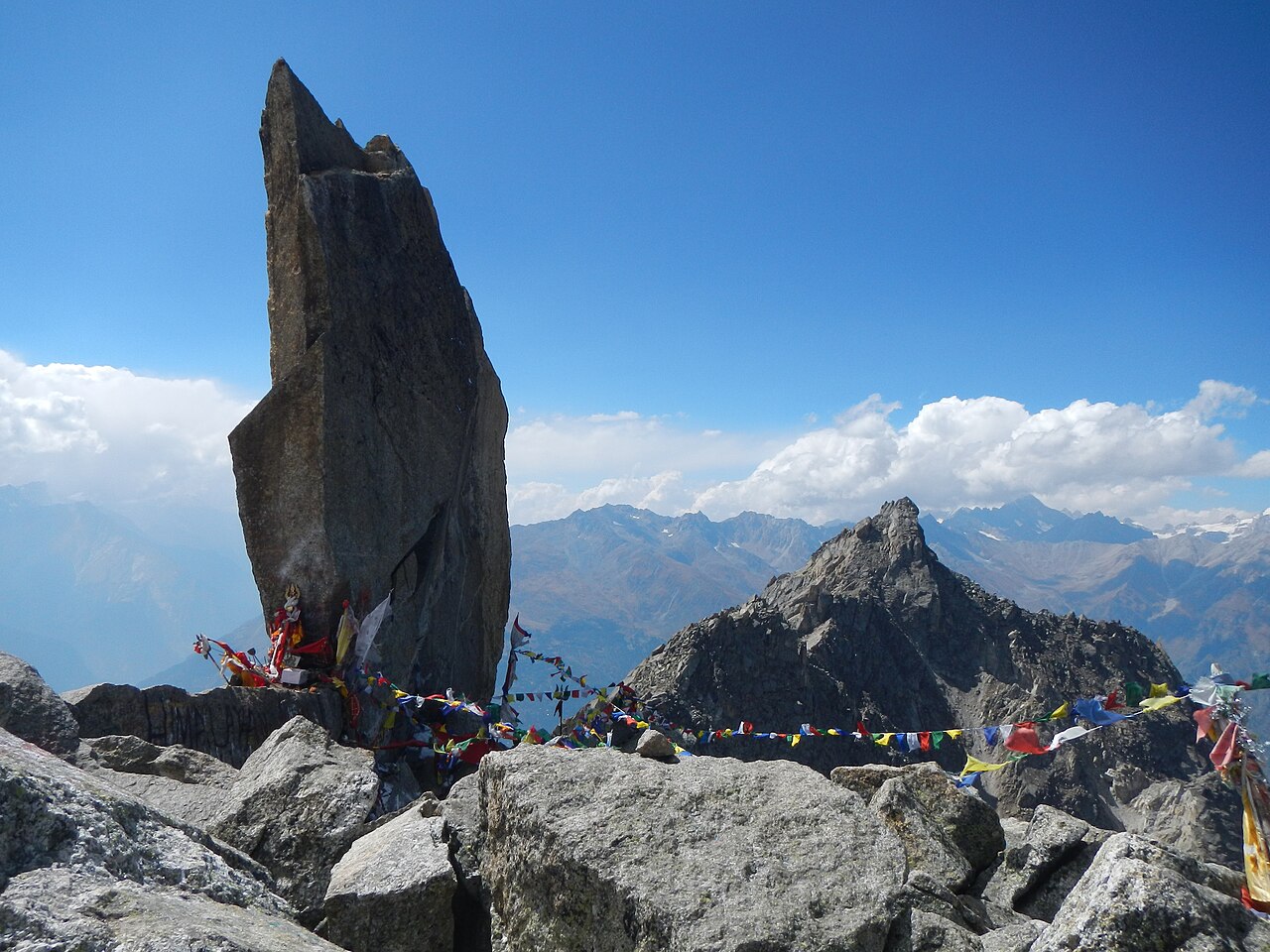 Prayer flags around the monolithic Shivling pillar on Kinnaur Kailash